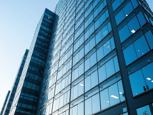 Modern office building exterior view with glass facade and corporate signage, showing professional business environment